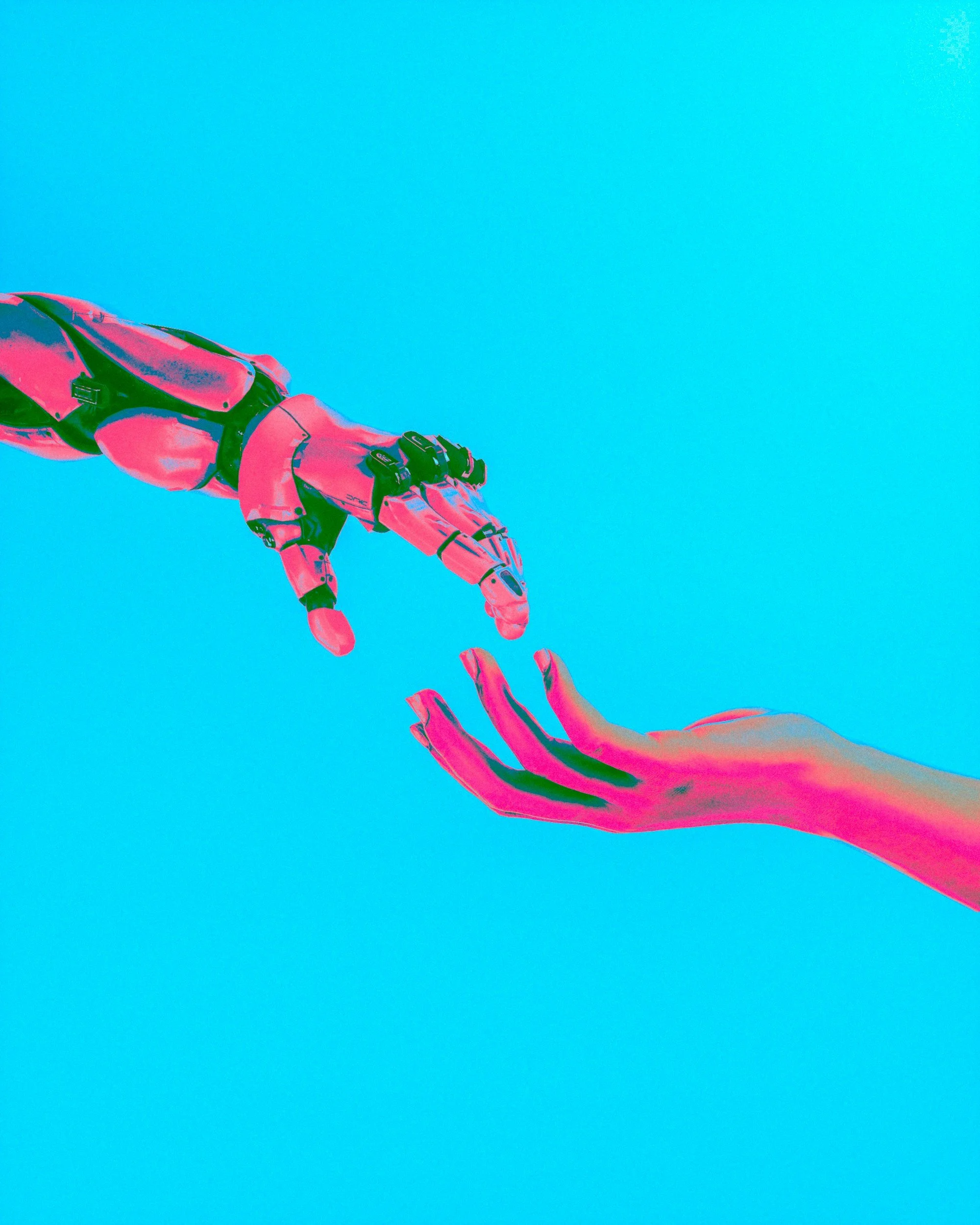 Robot arm reaching for a human hand against a vibrant blue background, symbolizing AI and humanity.